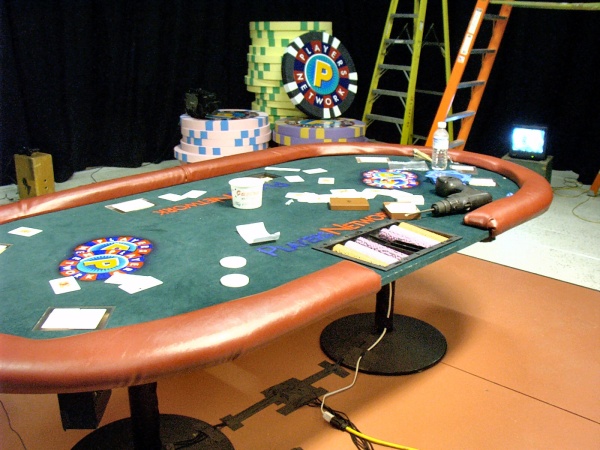 The TV Show's poker table during stage construction.  note the bundle of video and power cables pouring out from underneith.